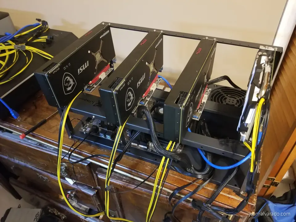 Mining rig mid-build on an open frame, with MSI graphics cards and yellow power cables