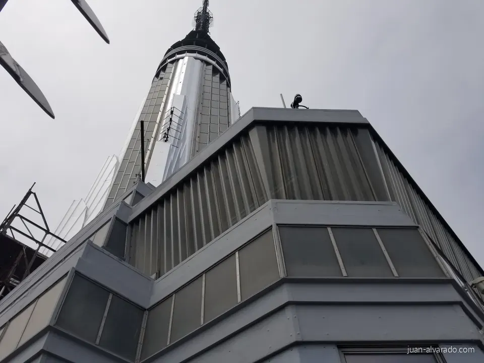 Looking up at the Empire State Building's spire