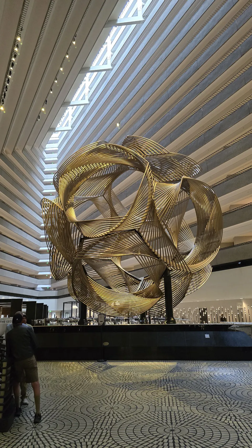Golden sculpture in a skylit atrium