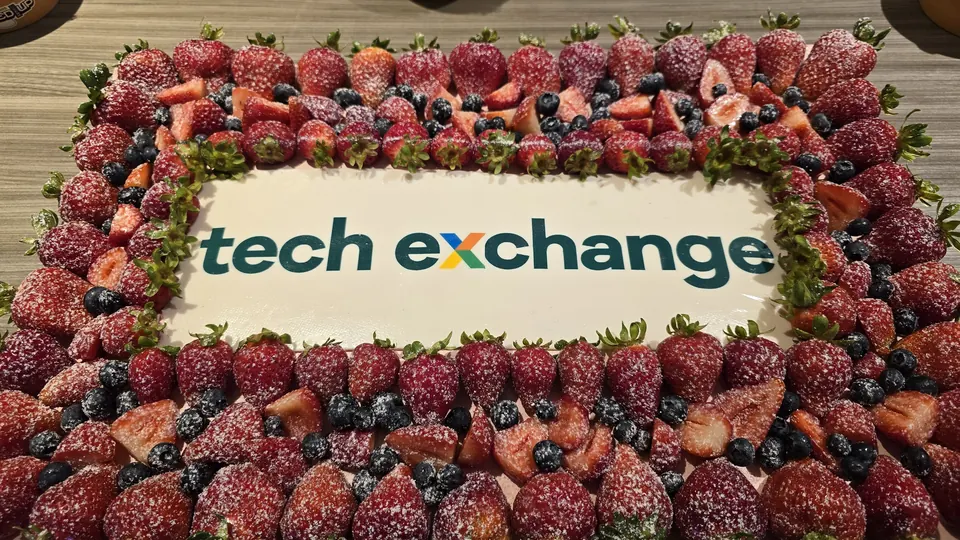 A "tech exchange" cake topped with berries