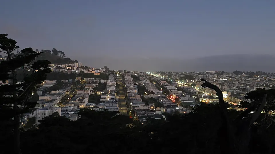City lights at dusk from a hilltop