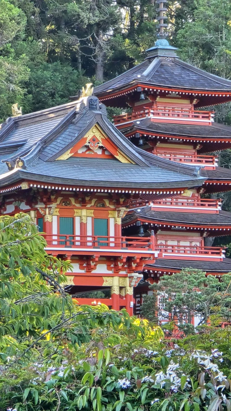 A pagoda surrounded by trees and flowers
