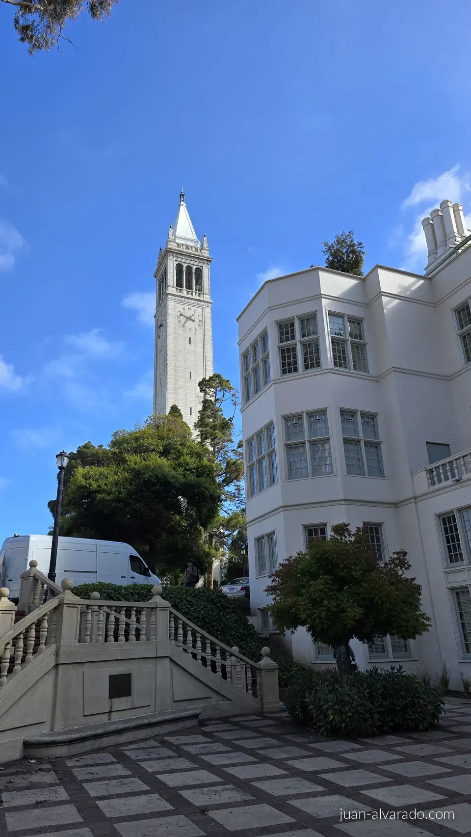 Sather Tower rising behind a campus building