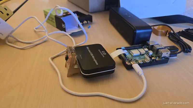 Raspberry Pi 4 wired to a USB microphone and a camera module on a desk